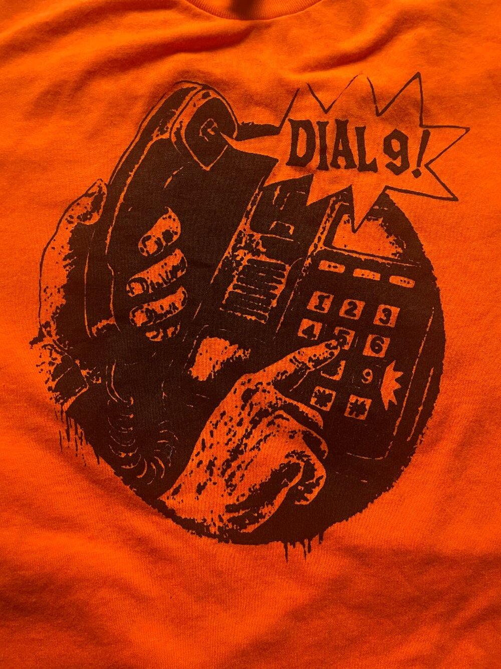 Orange "Dial 9" size medium t-shirt